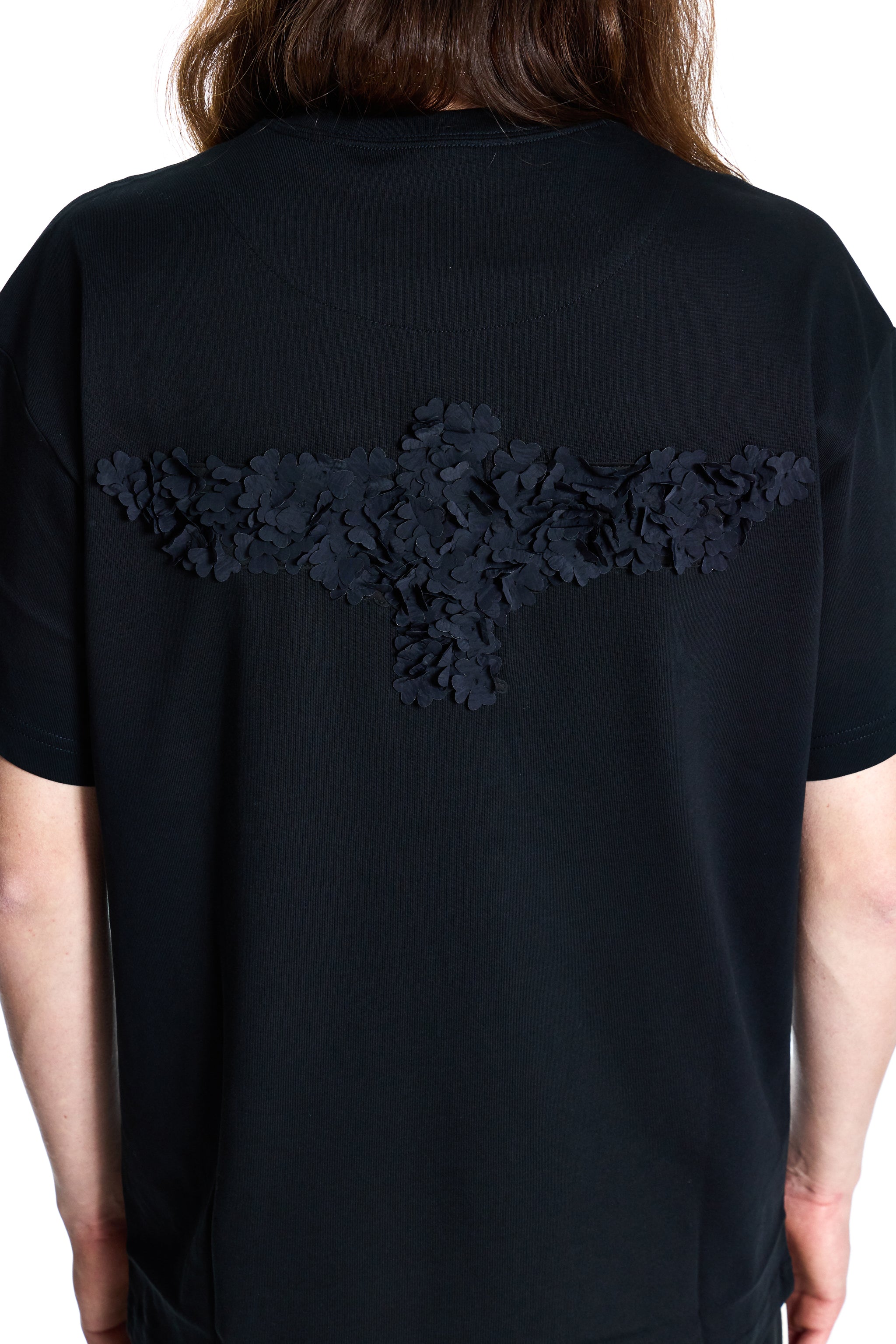 Black BOY London t-shirt with lace detailing on the back worn by a person