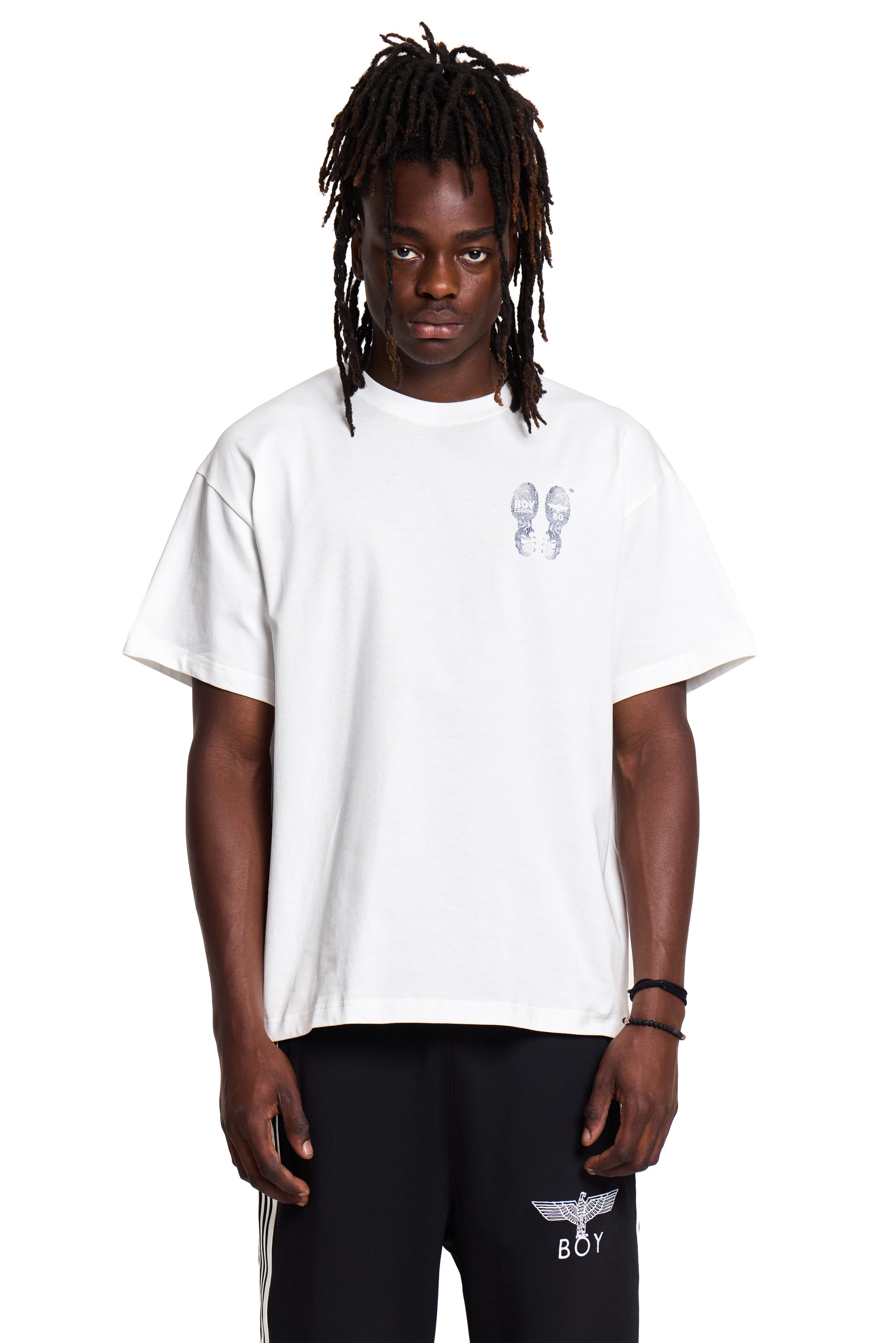 Person wearing a Boy London white t-shirt with a logo on a white background