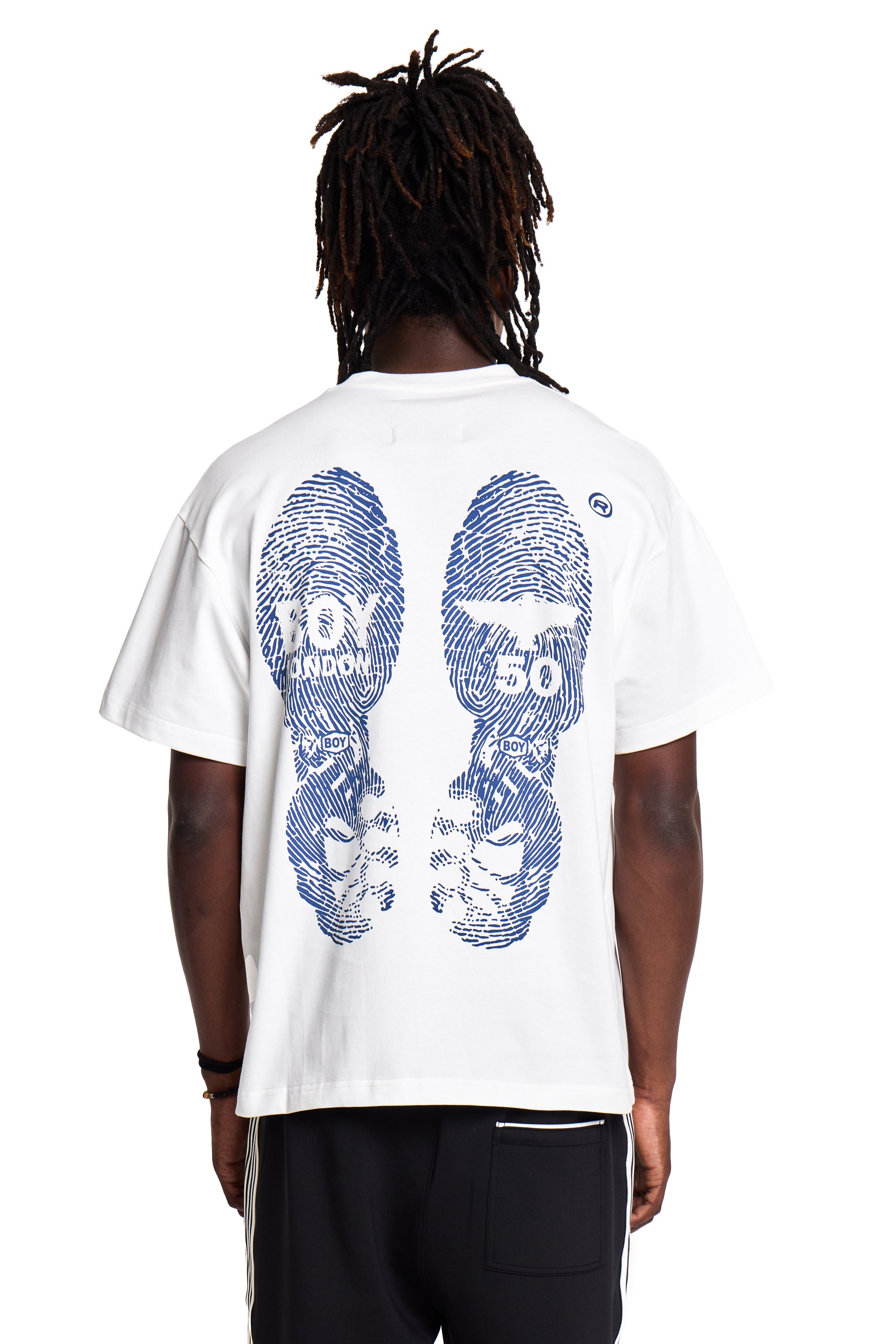 Person wearing a white Boy London t-shirt with blue graphic design on the back, standing against a white background