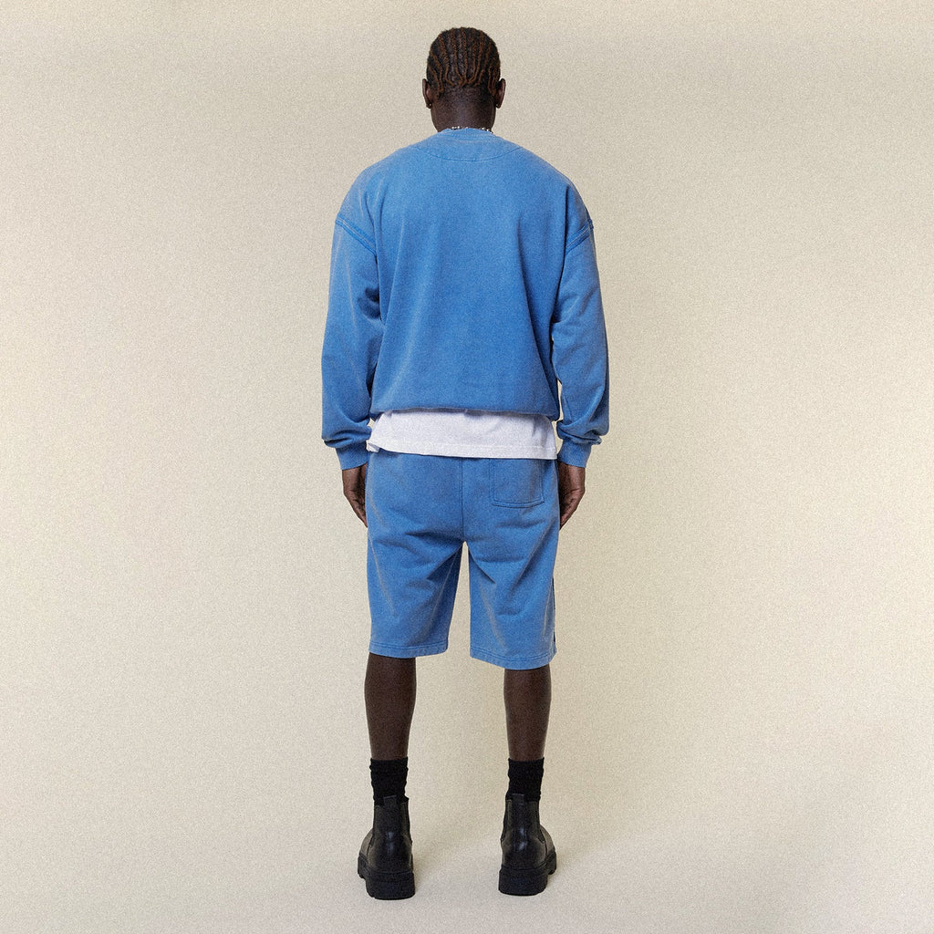 Model wearing BOY London shorts on plain background