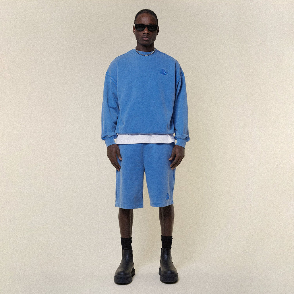 Model wearing BOY London shorts on plain background