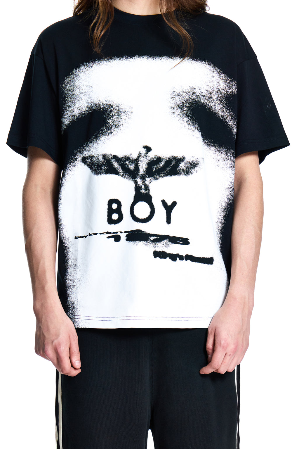 Person wearing a BOY London black t-shirt with a white graphic design and 'BOY' text.