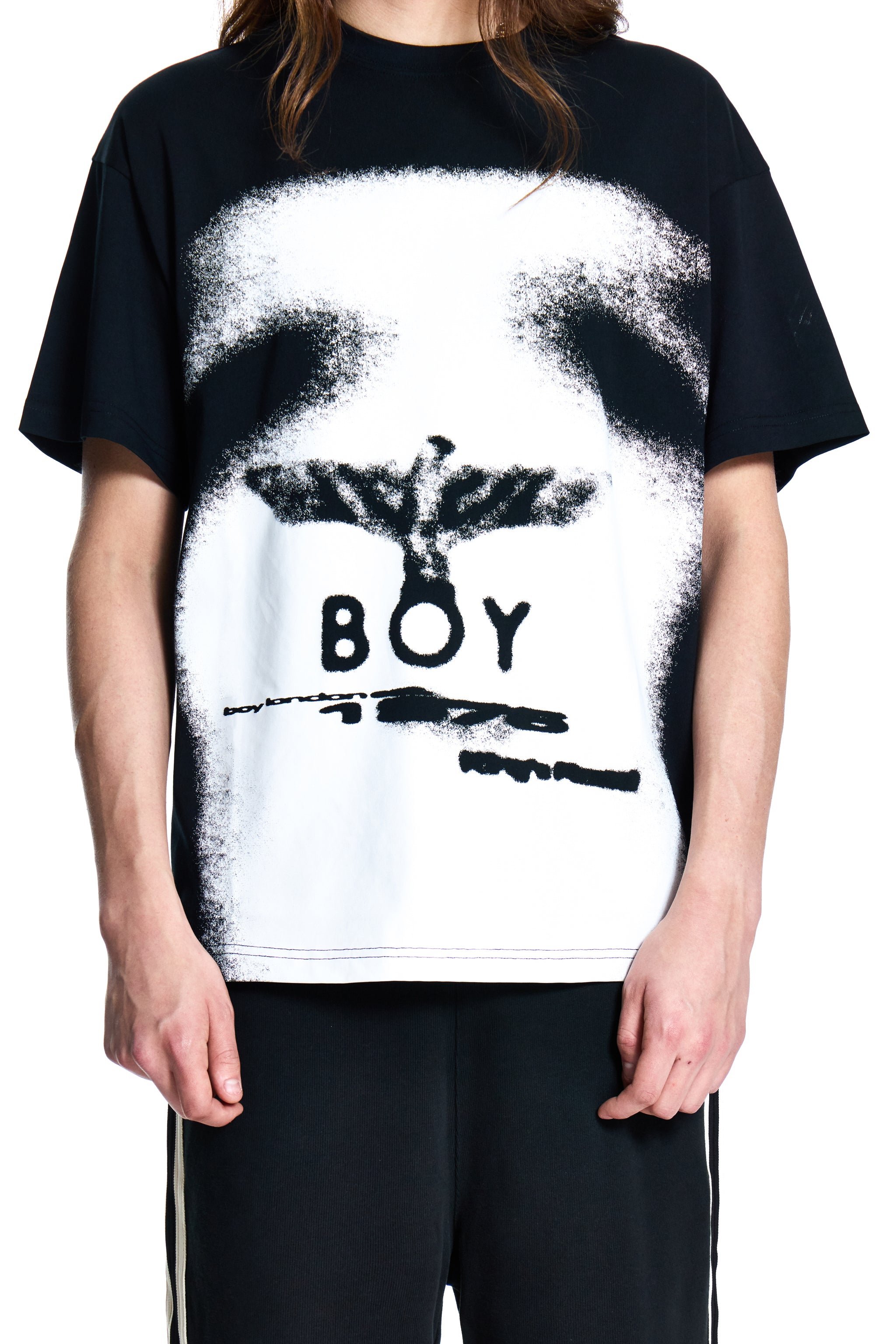 Person wearing a BOY London black t-shirt with a white graphic design and 'BOY' text.