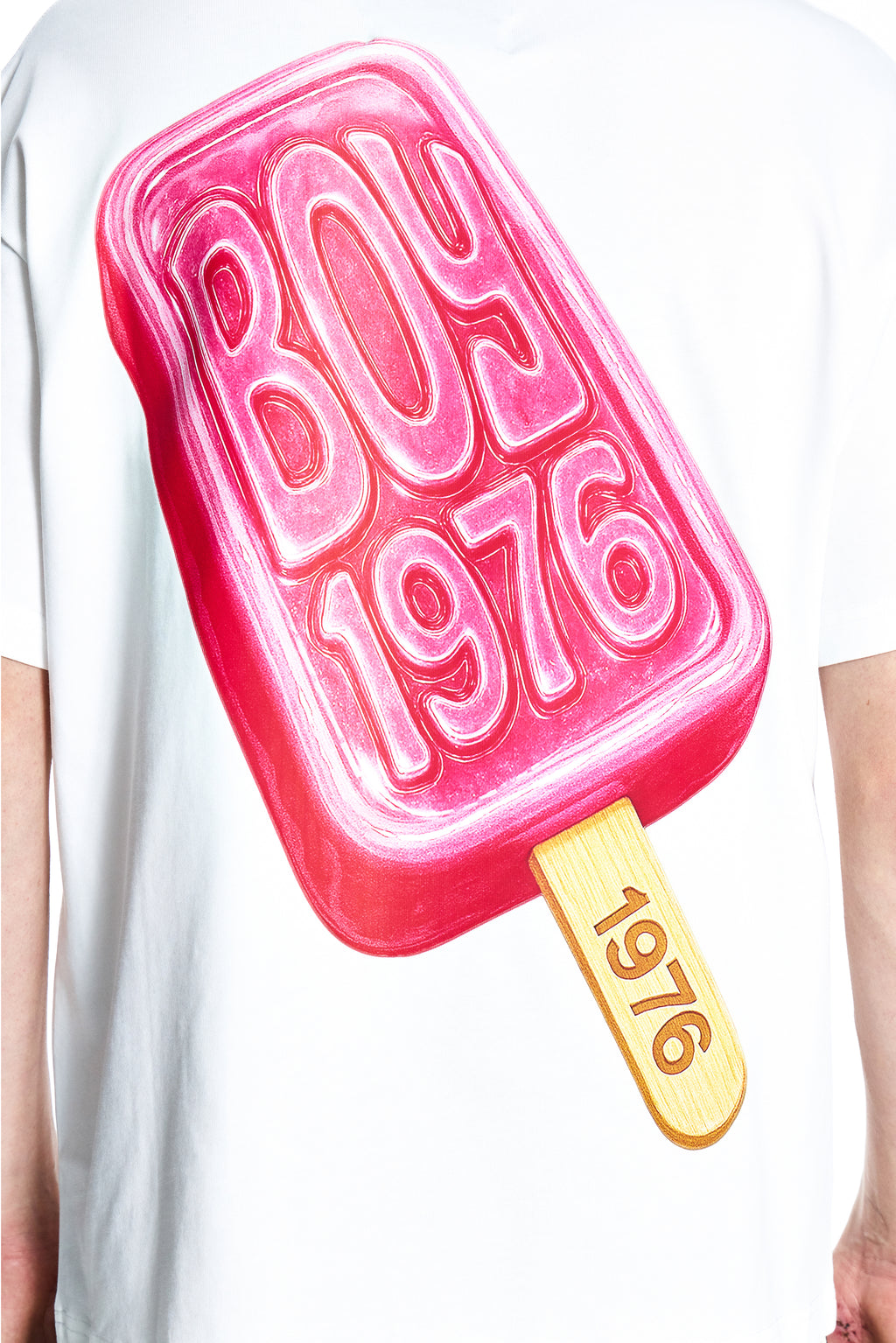 White t-shirt with a pink ice cream popsicle design featuring the text 'Born 1976'.