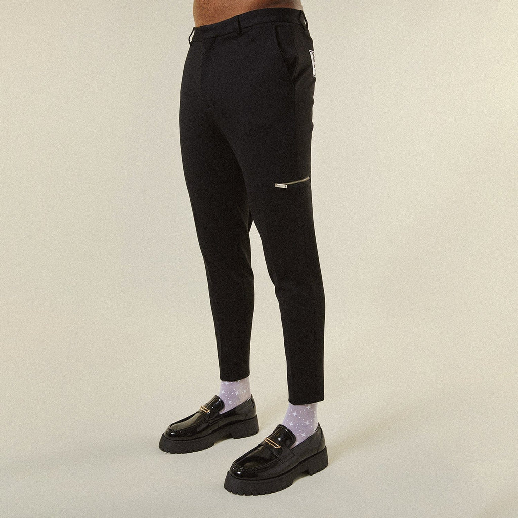 Model wearing BOY London trousers on white background