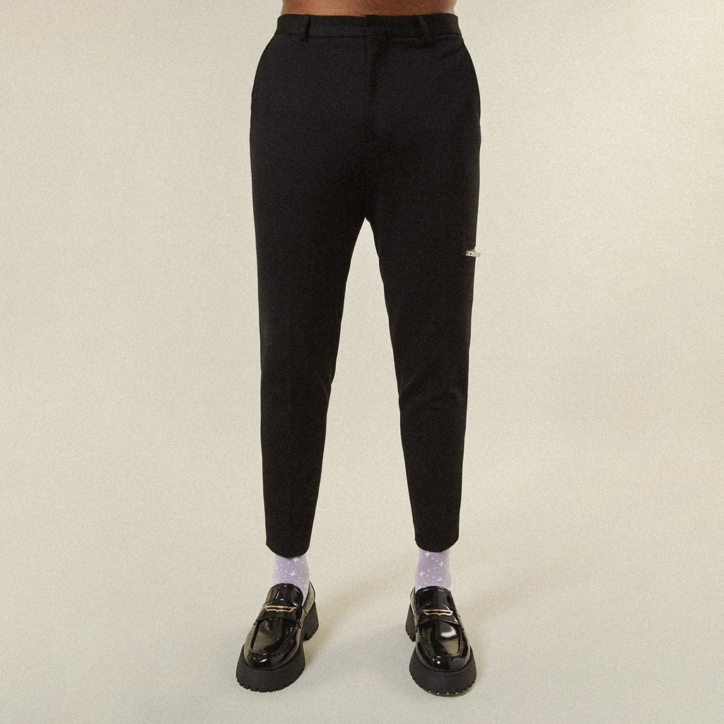 Model wearing BOY London trousers on white background