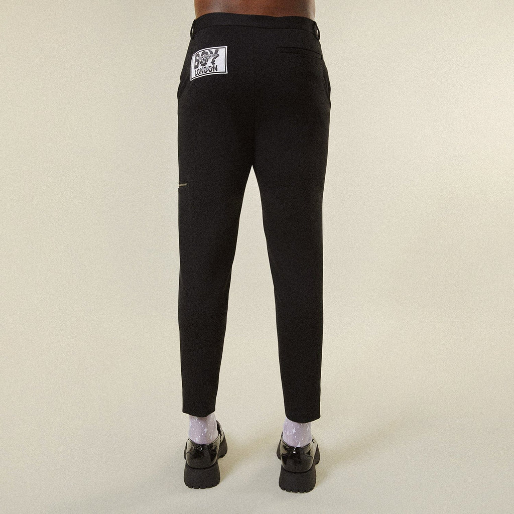 Model wearing BOY London trousers on white background