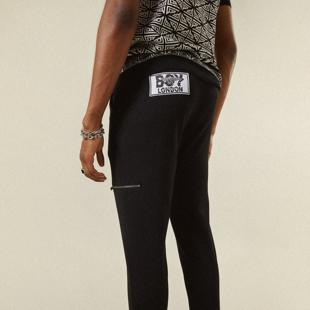 Model wearing BOY London trousers on white background