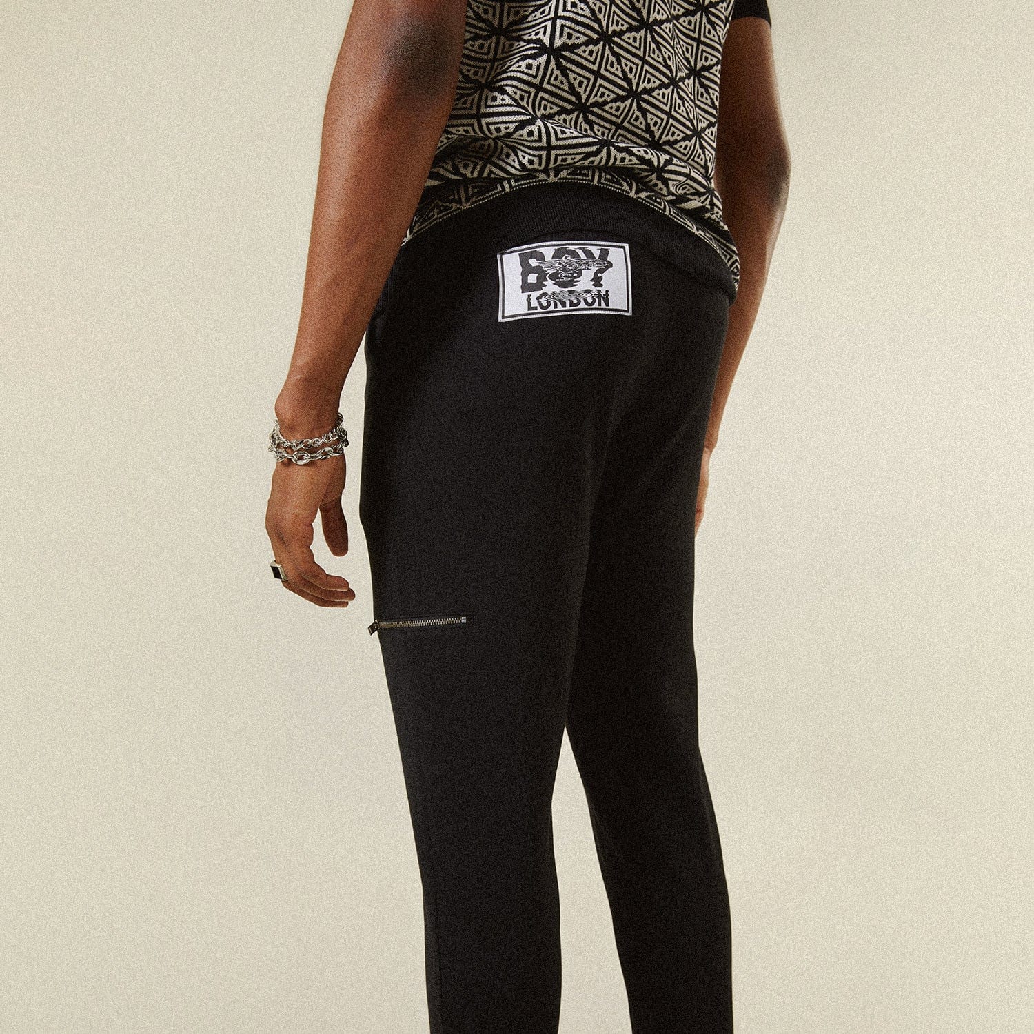 Model wearing BOY London trousers on white background
