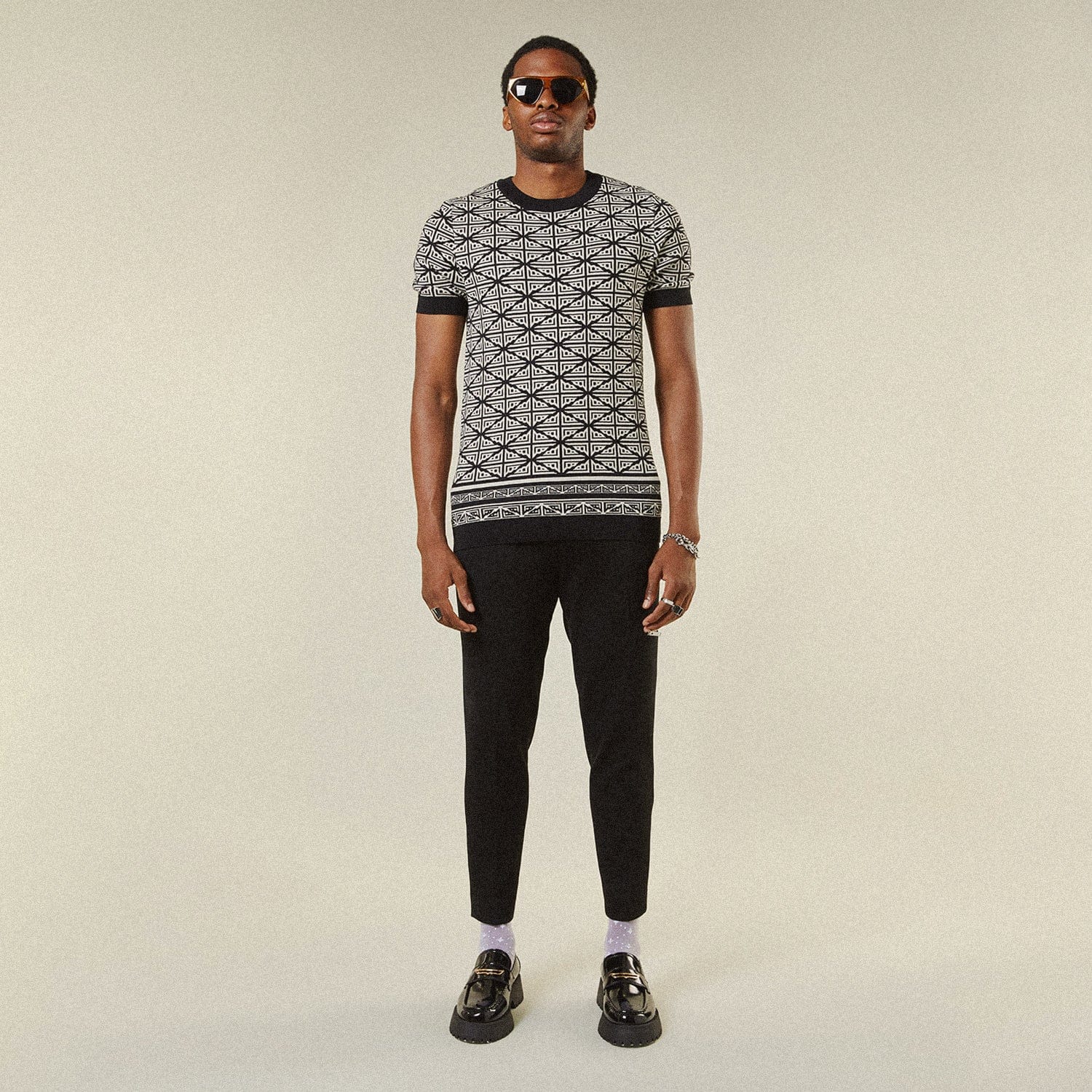 Model wearing BOY London trousers on white background