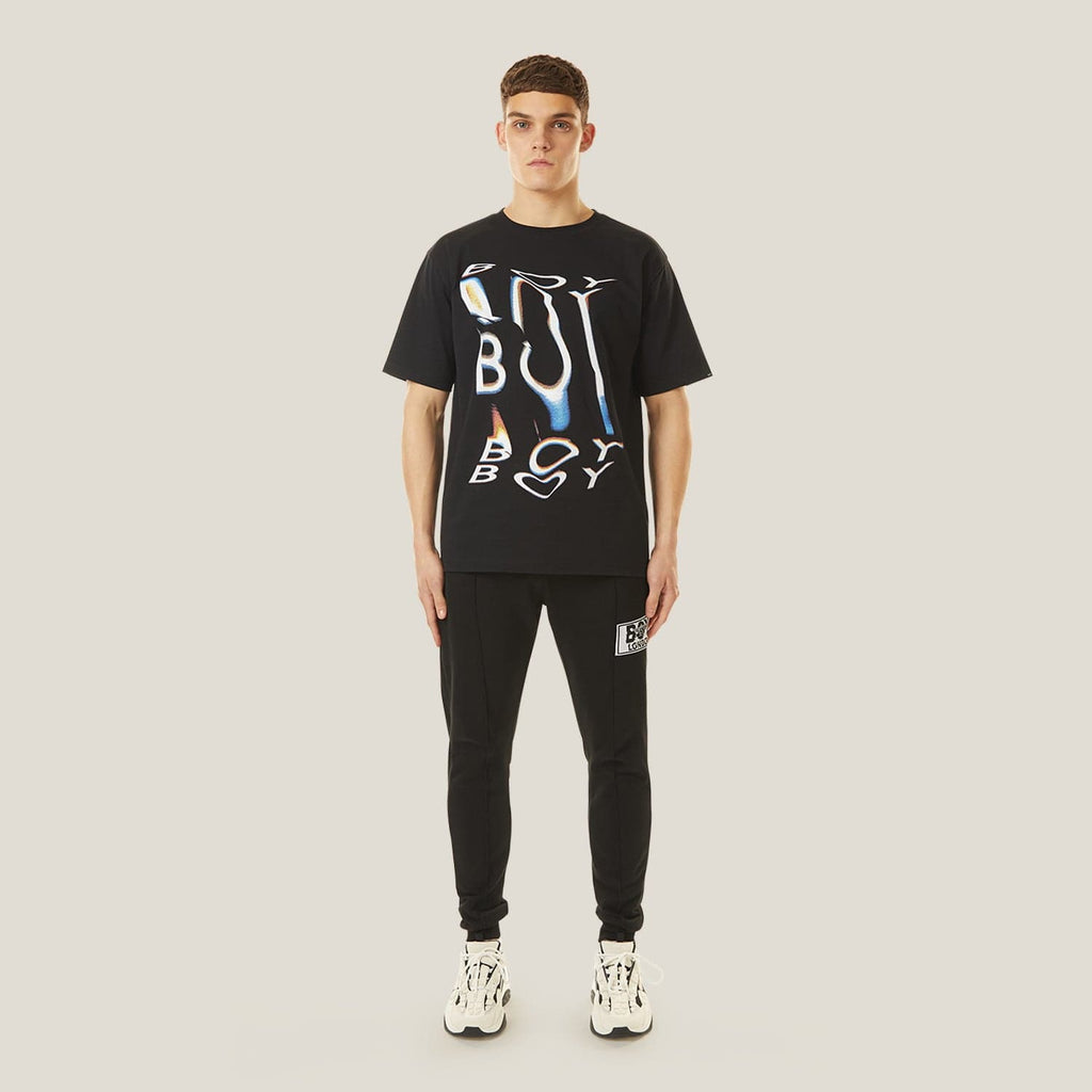 Model wearing boy london joggers on plain background