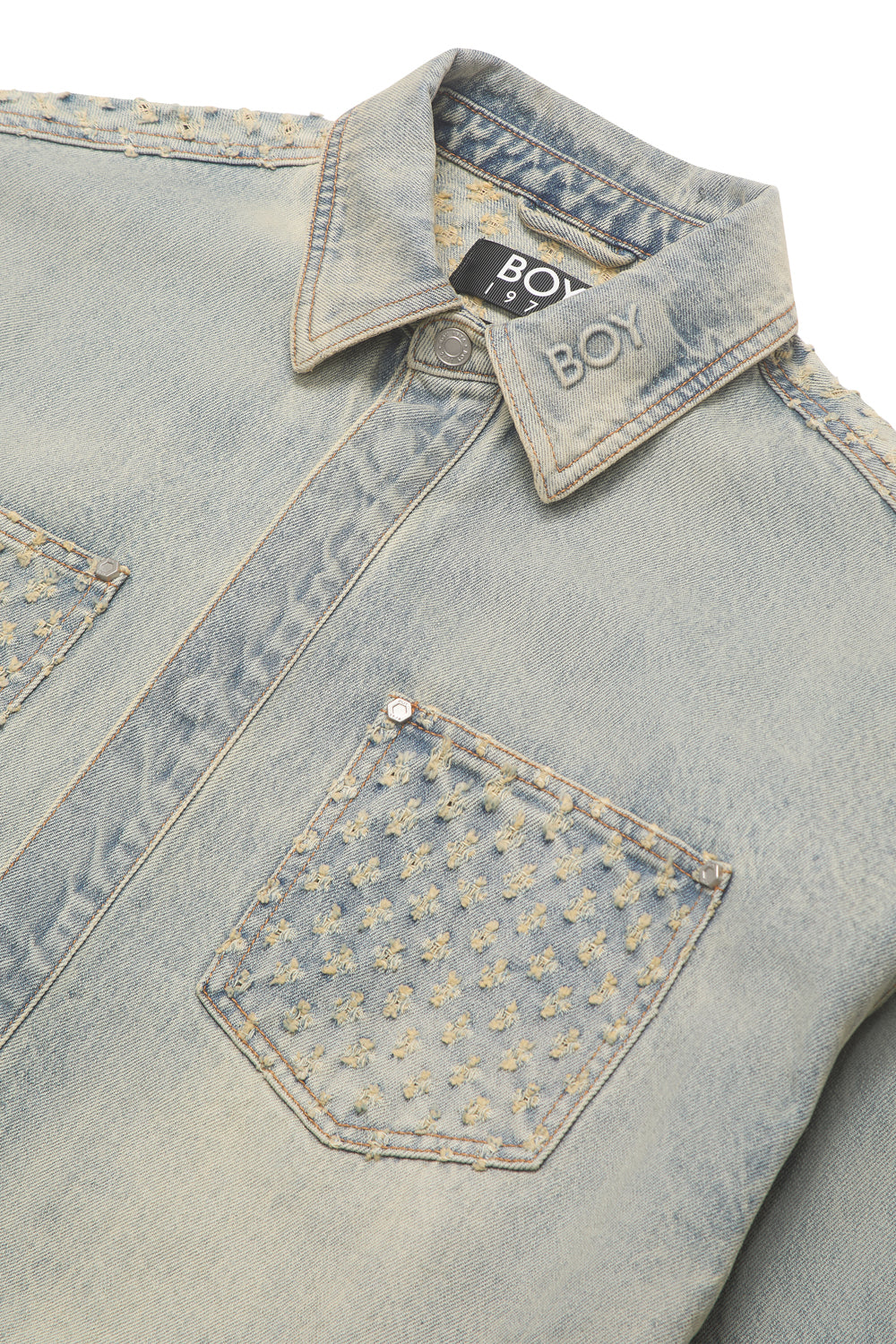 Light blue denim jacket with floral patterns on a white background