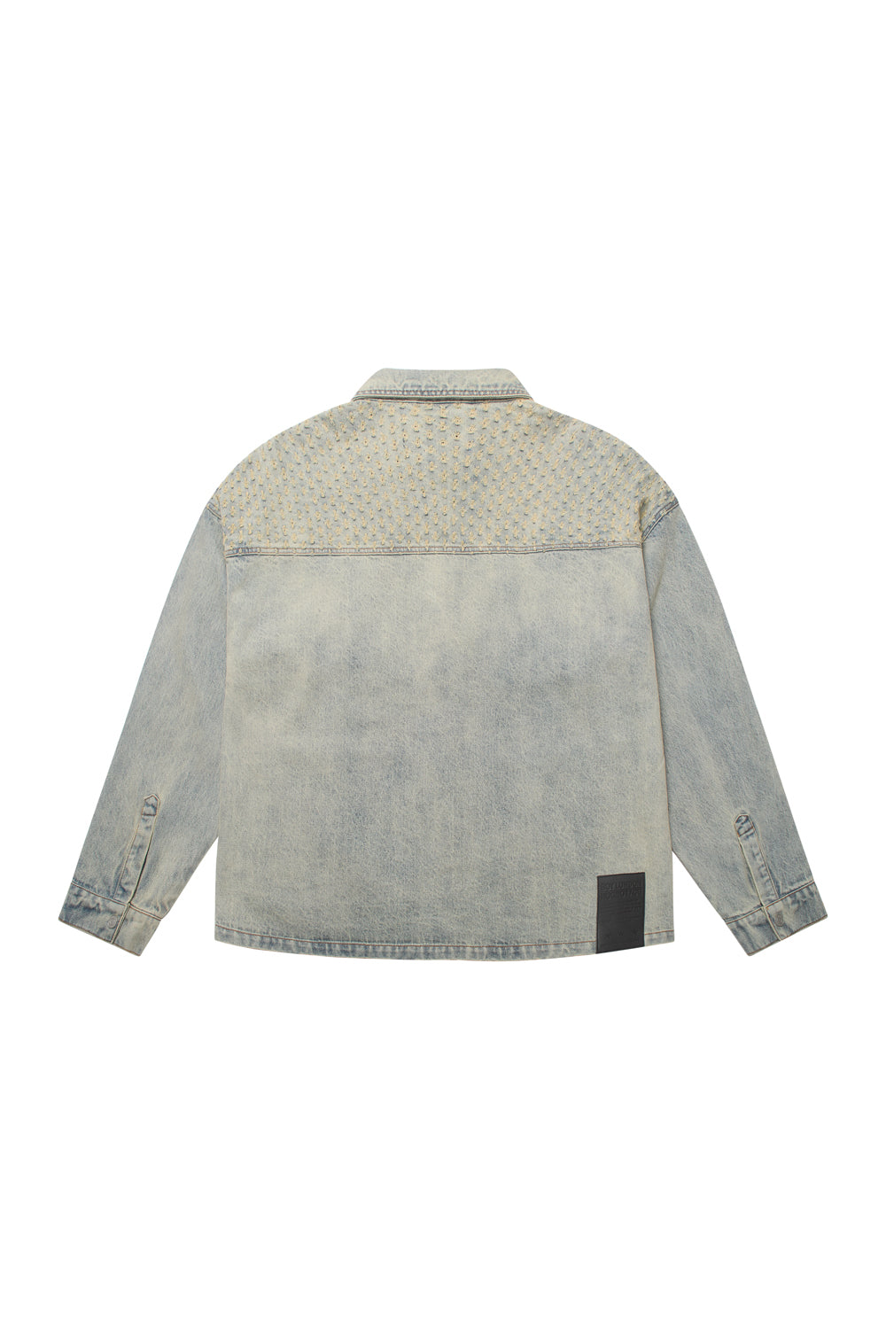 Back view of a denim jacket with a patterned patch on a white background