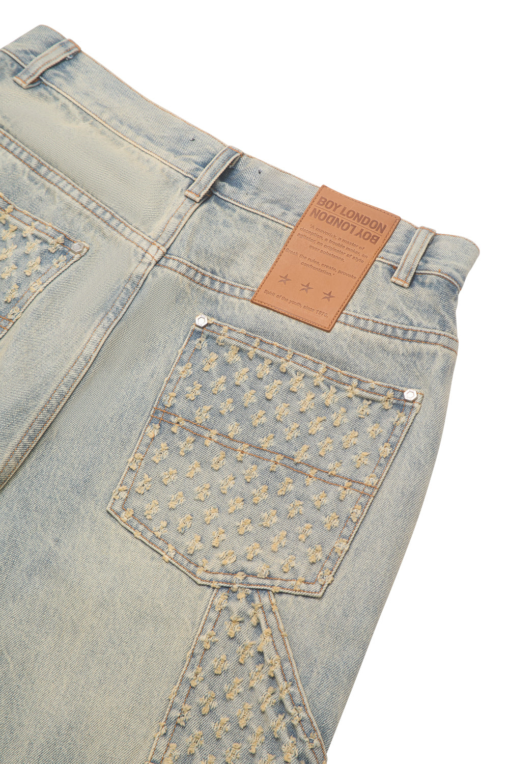 Light blue denim BOY London  jeans with floral embroidery on a white background
