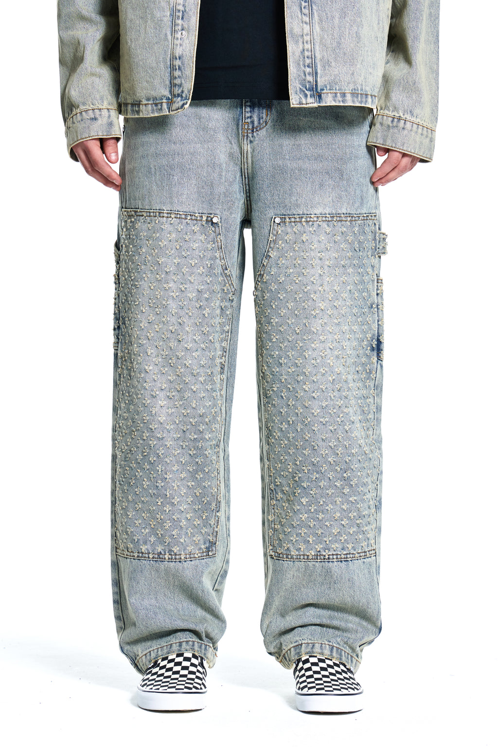 Light blue Boy London jeans worn by a person on a white background
