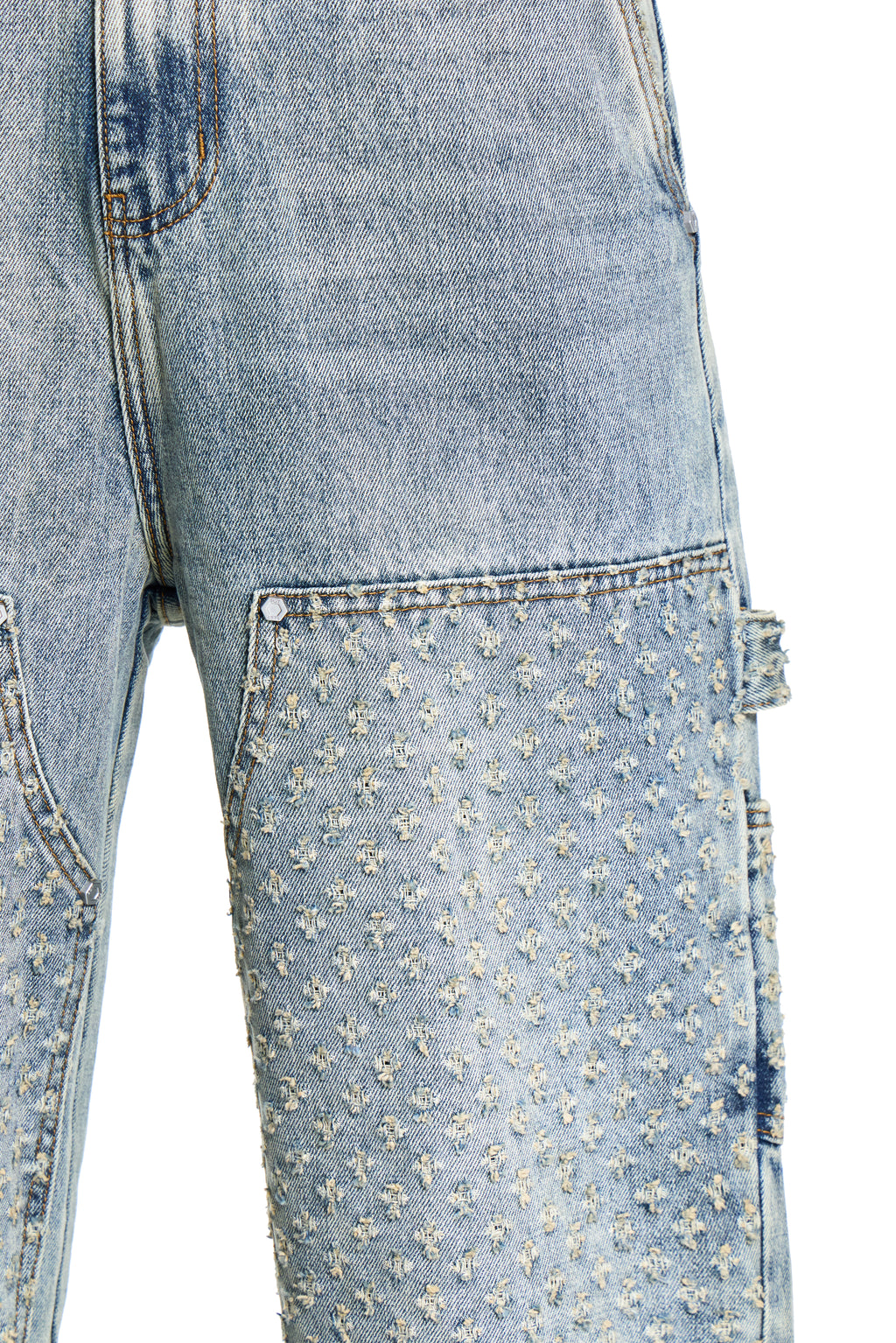 Close-up of light blue BOY London jeans with floral pattern on a white background