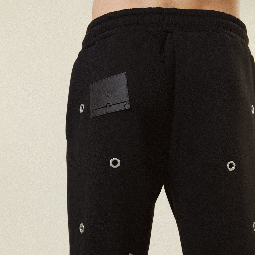 Model wearing BOY London trousers on white background