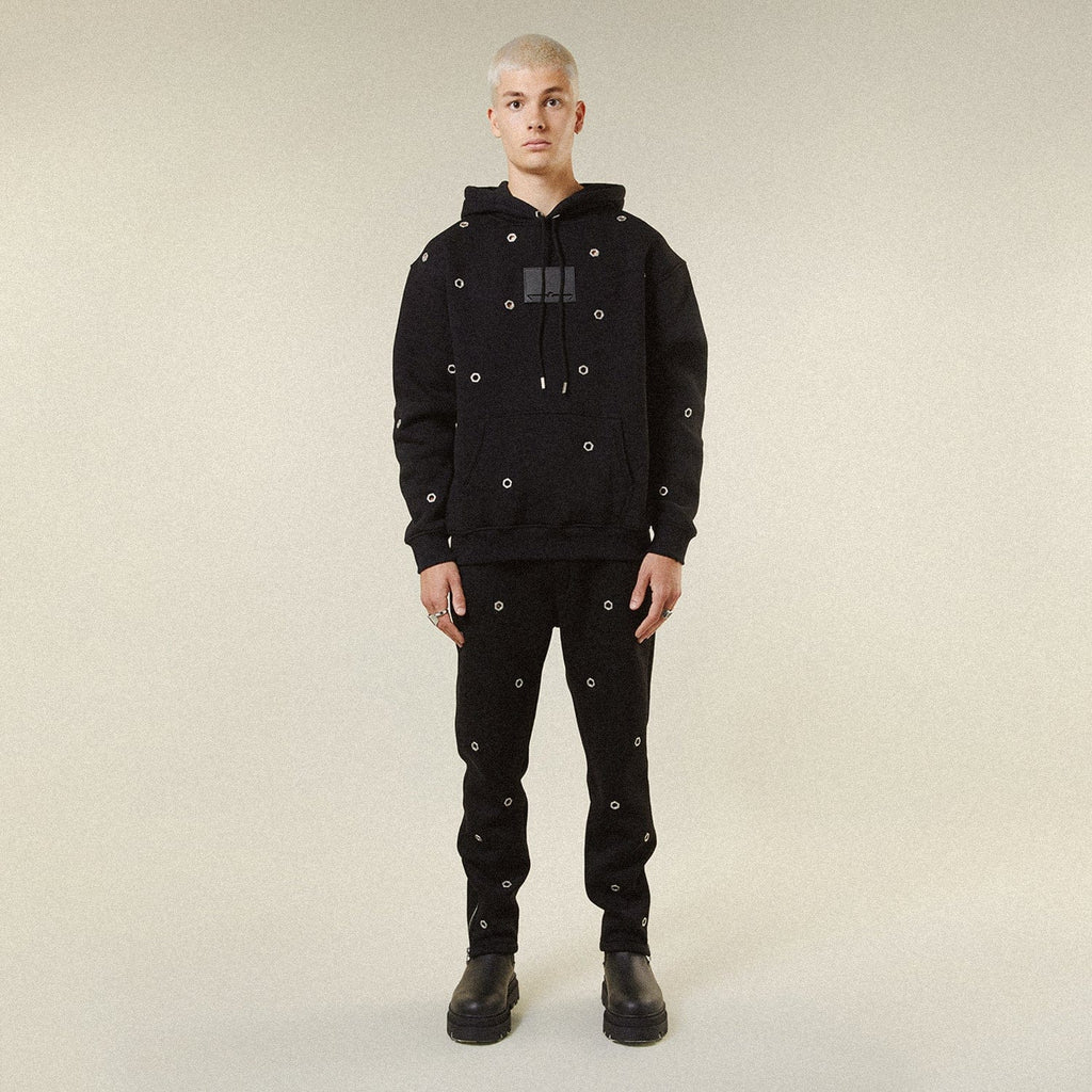 Model wearing BOY London trousers on white background