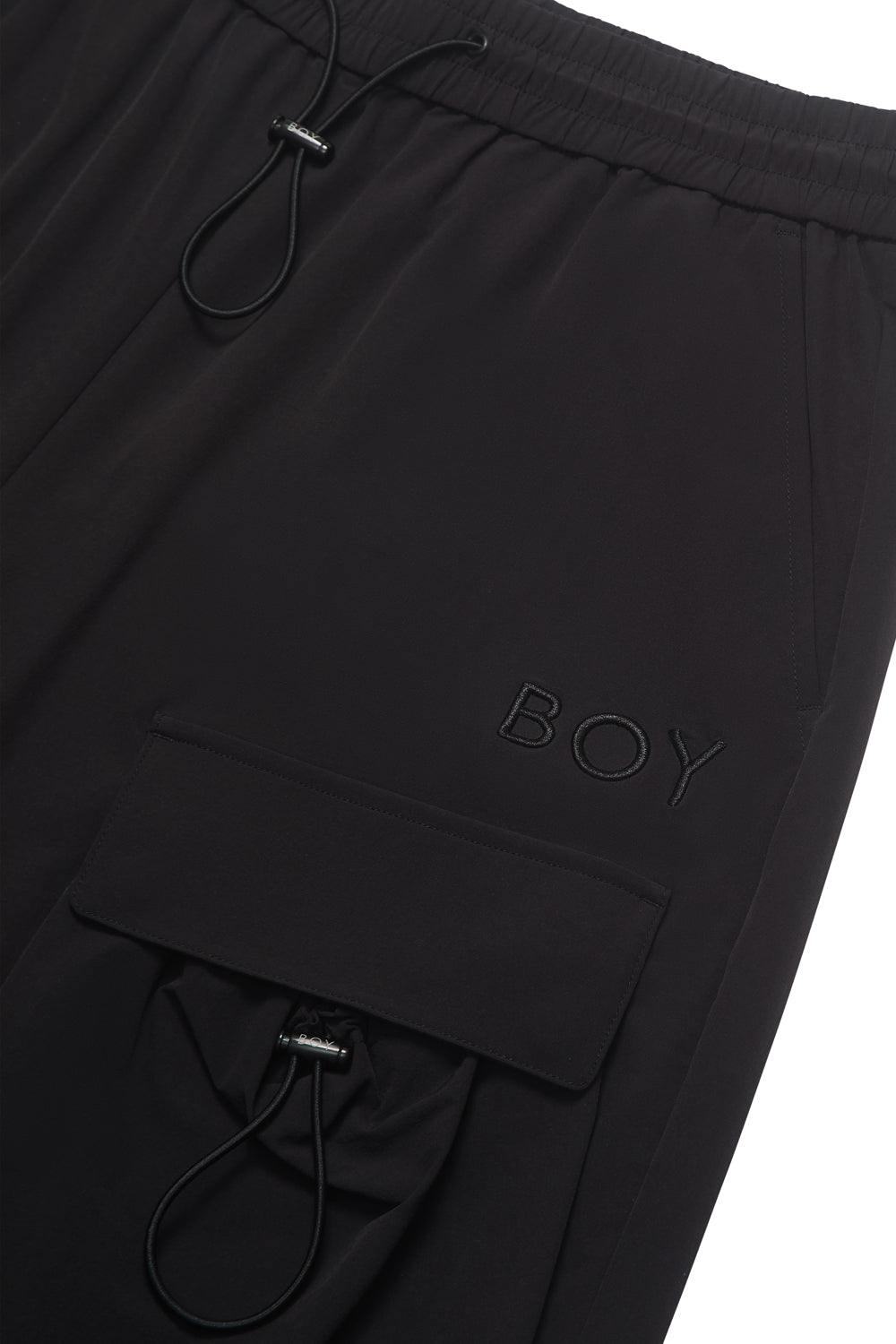 Black pants with 'BOY' branding on a white background