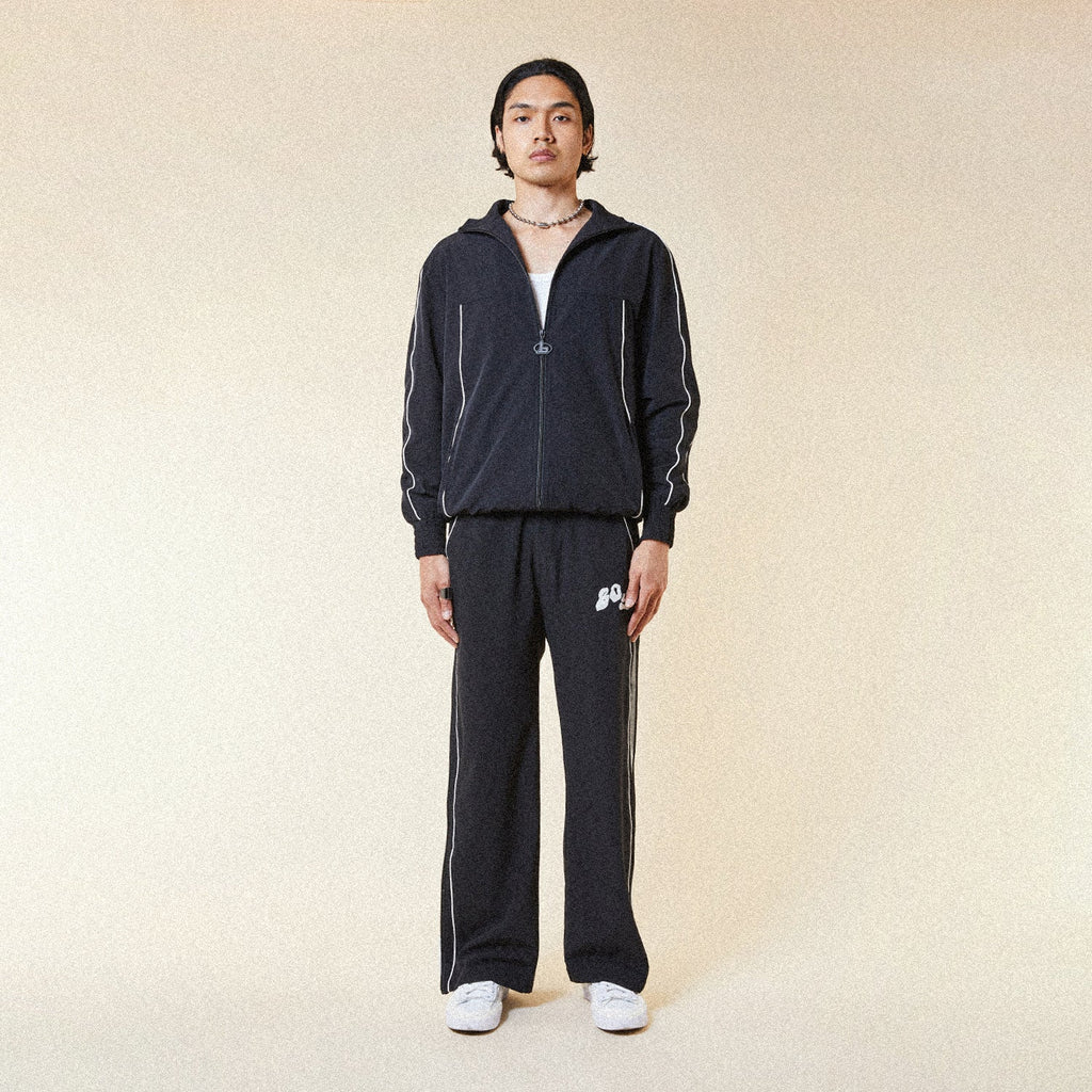 Black BOY London pants with white text on a white background