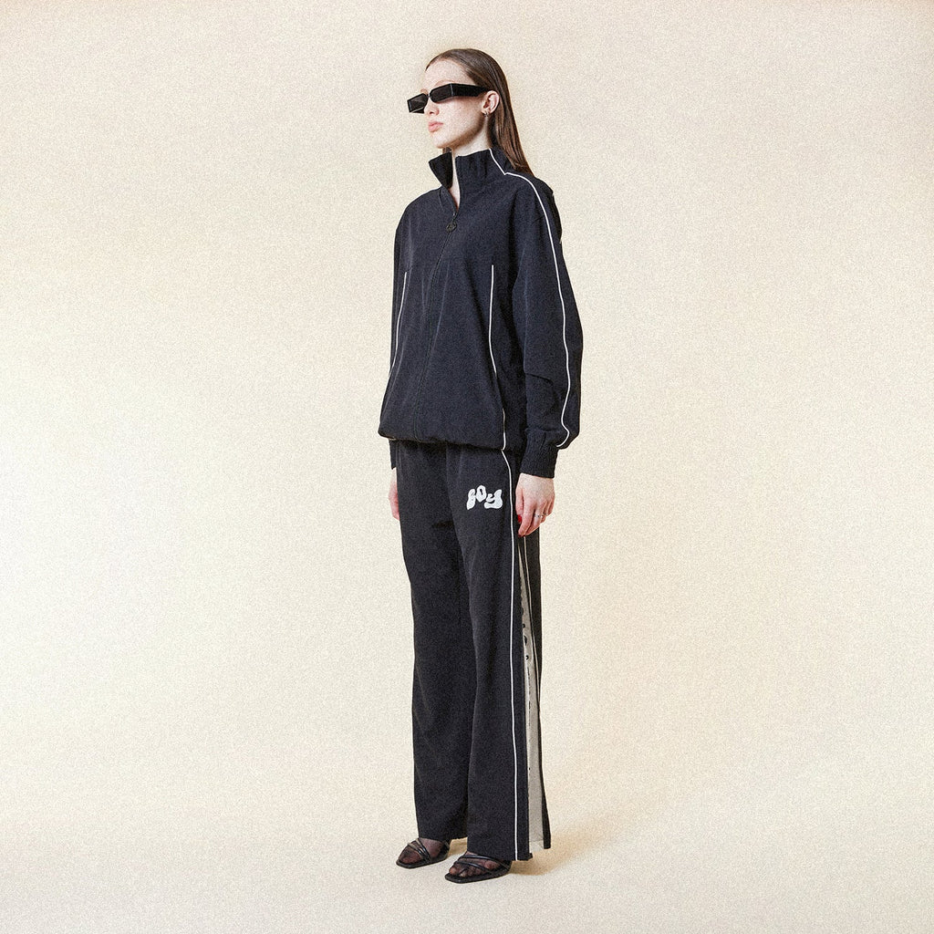 Black BOY London pants with white text on a white background