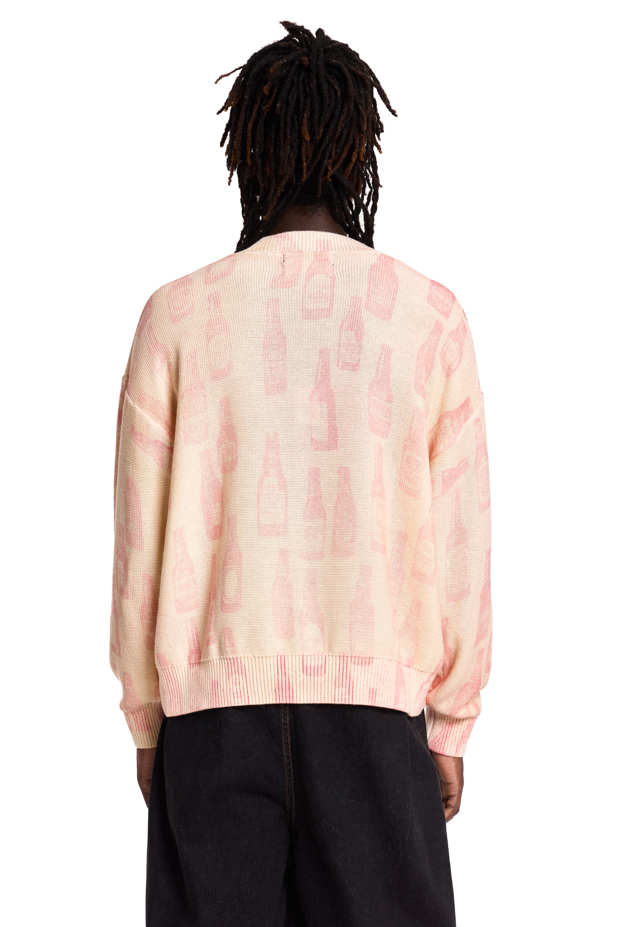 Person wearing a pink Boy London tie-dye sweater on a white background