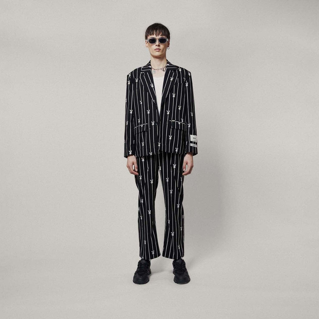 Model wearing BOY London Black blazer with white patterns on a white background