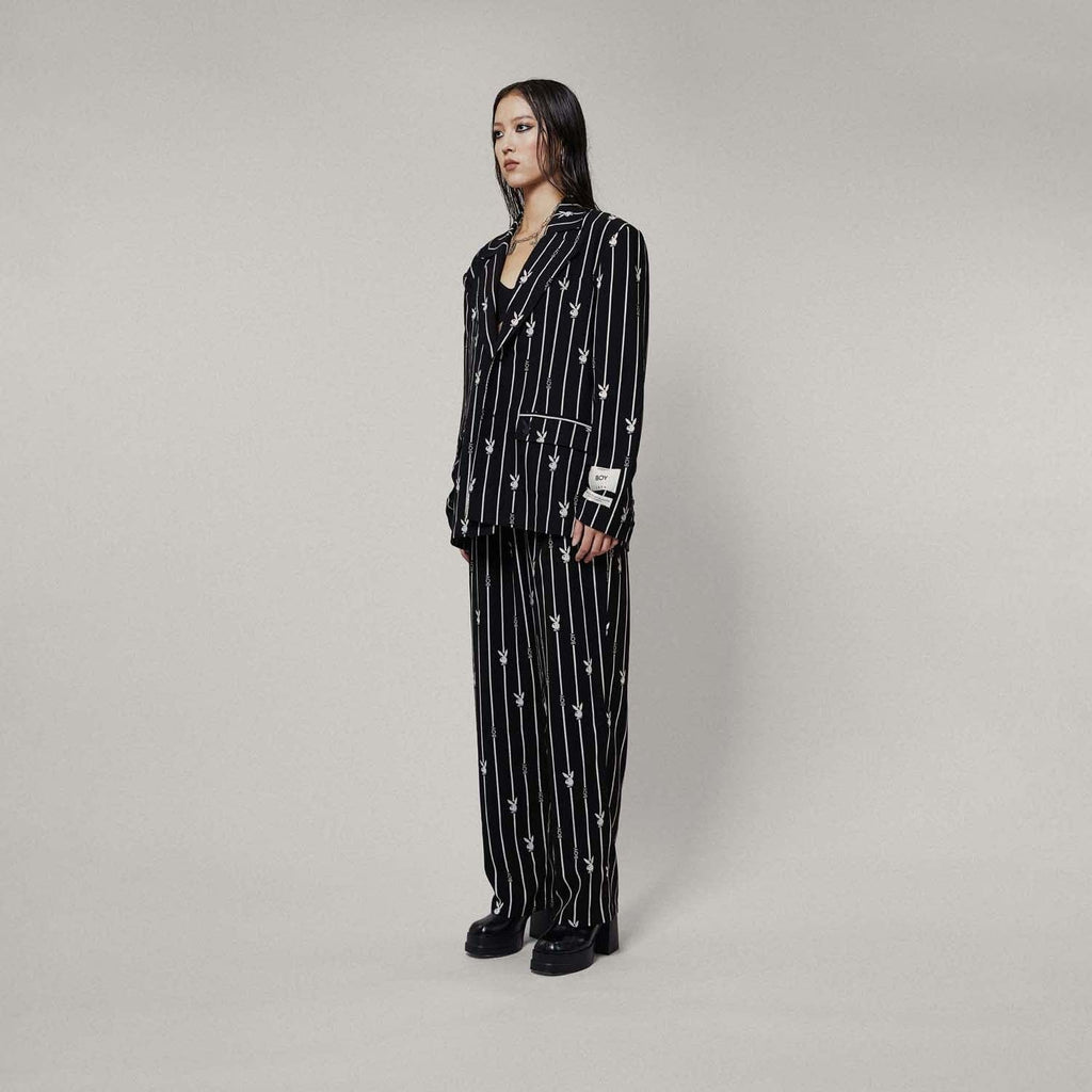 Model wearing BOY London Black blazer with white patterns on a white background