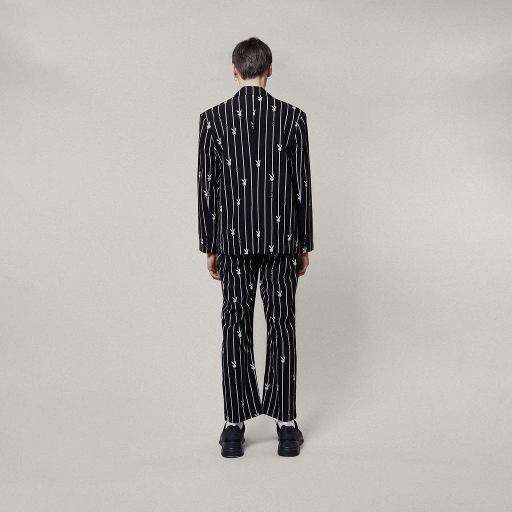 Model wearing BOY London Black blazer with white patterns on a white background