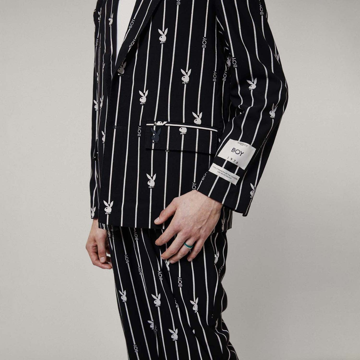 Model wearing BOY London Black blazer with white patterns on a white background
