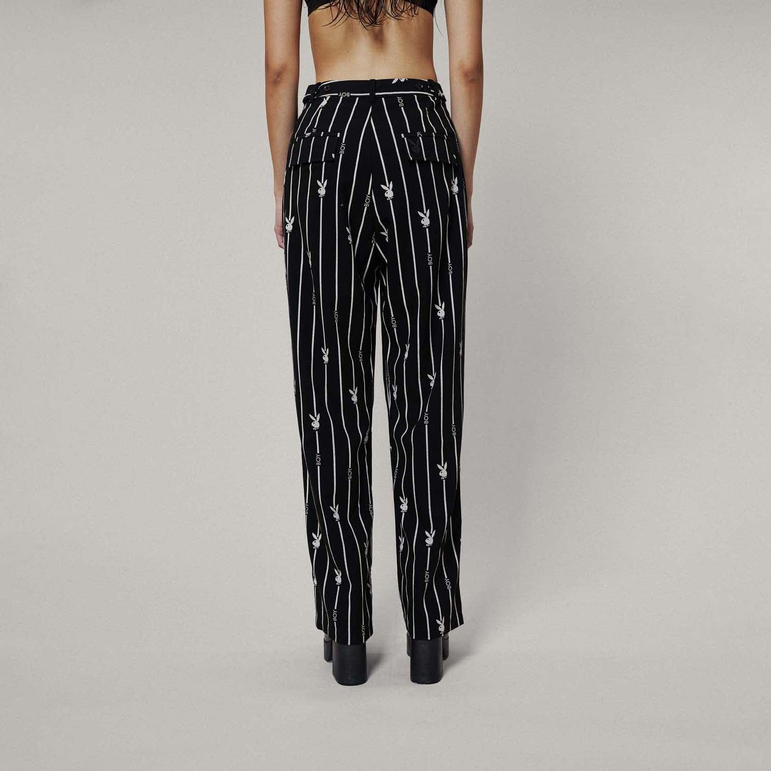 Model wears BOY London trousers on white background