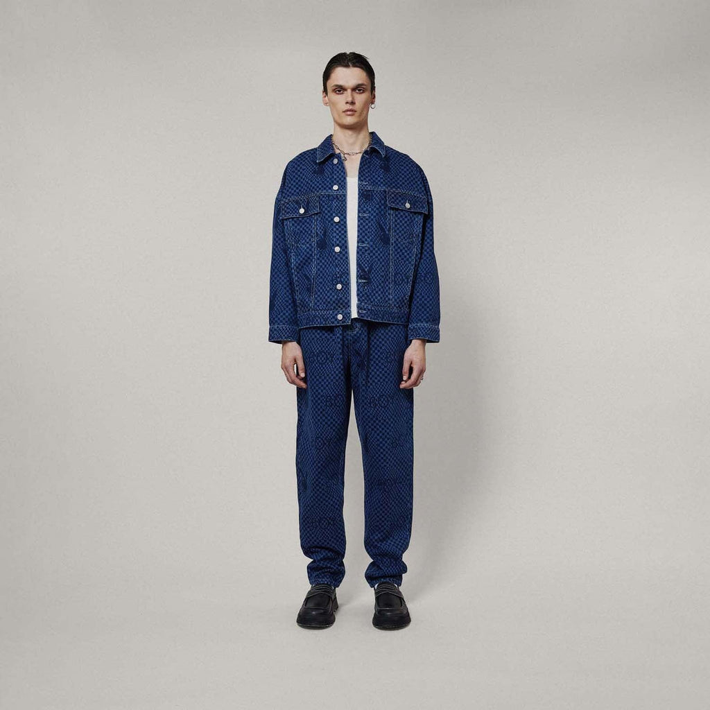 Model wearing Blue BOY London denim jacket with white buttons on a white background