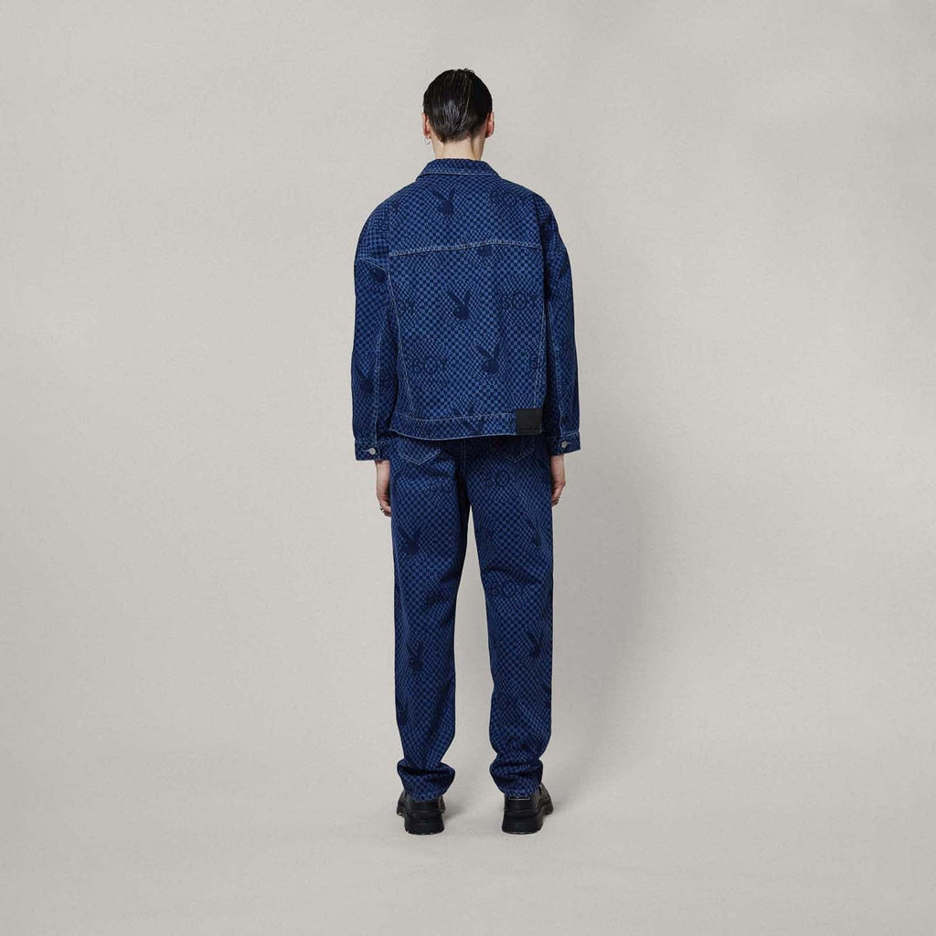 Model wearing Blue BOY London denim jacket with white buttons on a white background