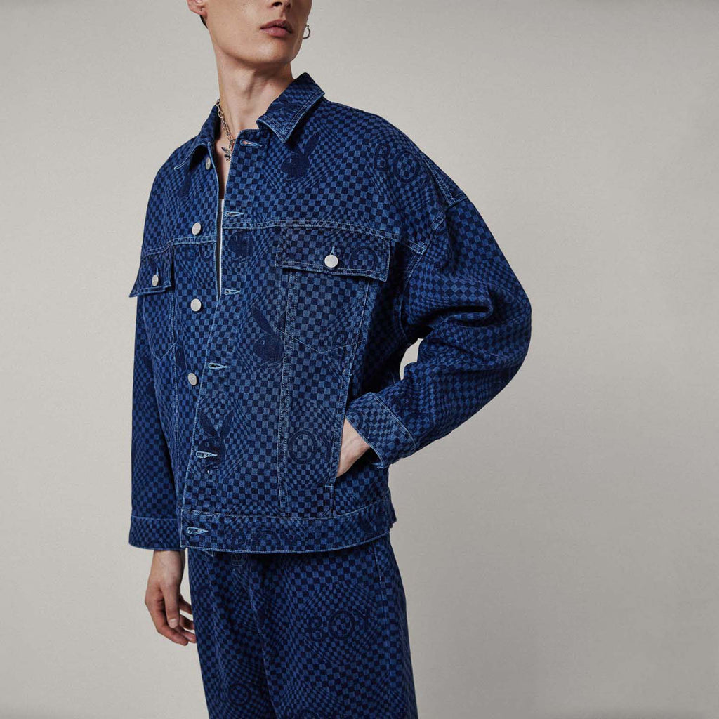 Model wearing Blue BOY London denim jacket with white buttons on a white background