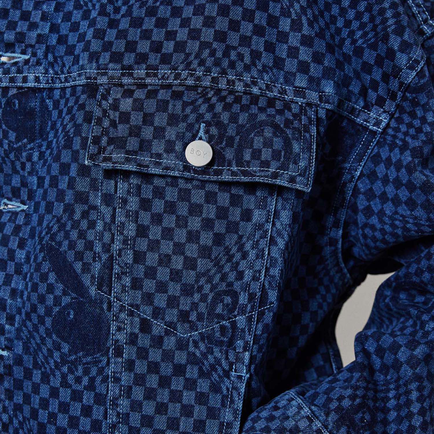 Model wearing Blue BOY London denim jacket with white buttons on a white background