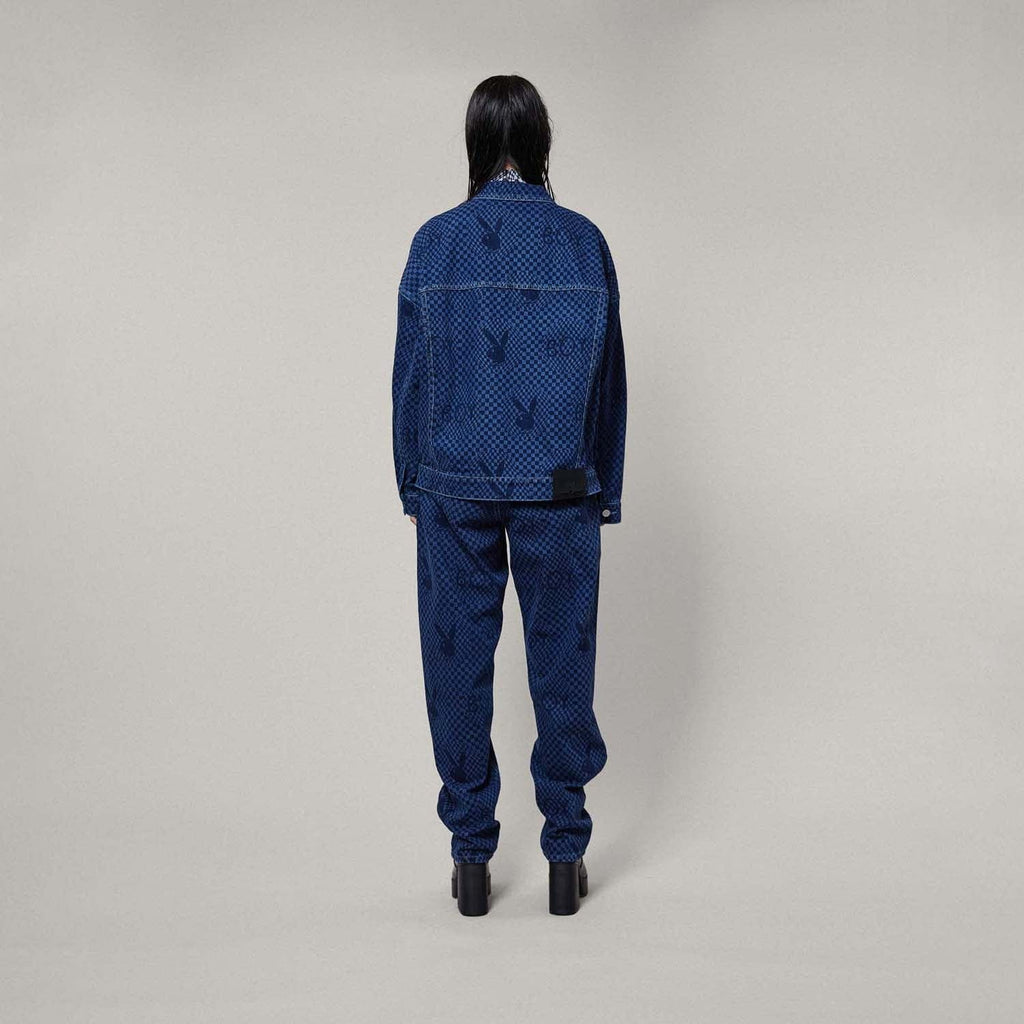 Model wearing Blue BOY London denim jacket with white buttons on a white background