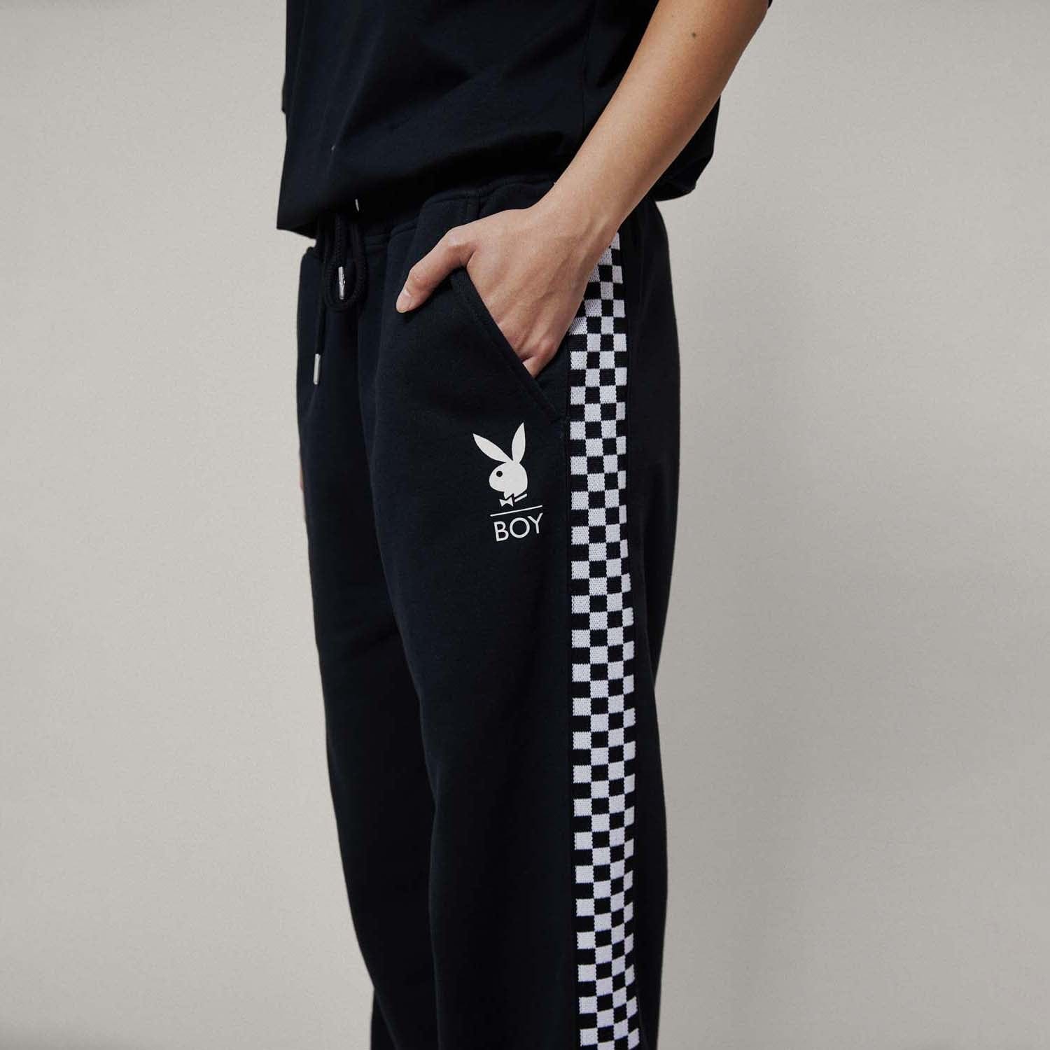 Model wearing boy london joggers on white background
