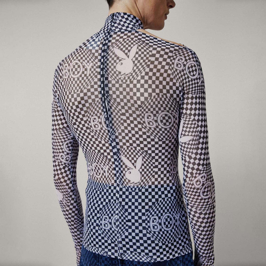 Model wearing Black and white checkered BOY London top with graphic design on a white background
