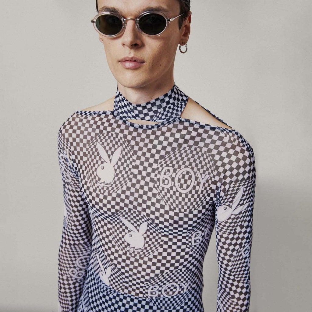 Model wearing Black and white checkered BOY London top with graphic design on a white background