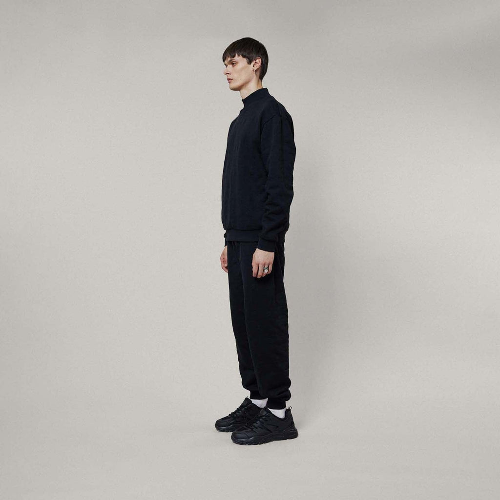 Model wearing Black jogger pants on a white background