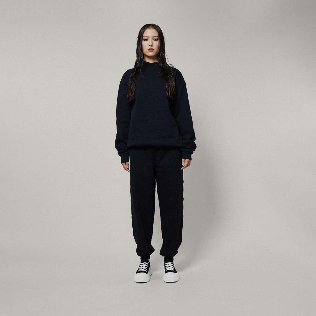 Model wearing Black jogger pants on a white background