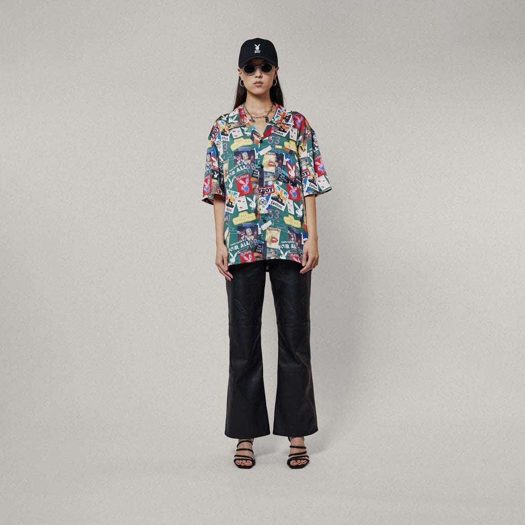 Model wearing Colourful BOY London patterned shirt with brand logos on a white background