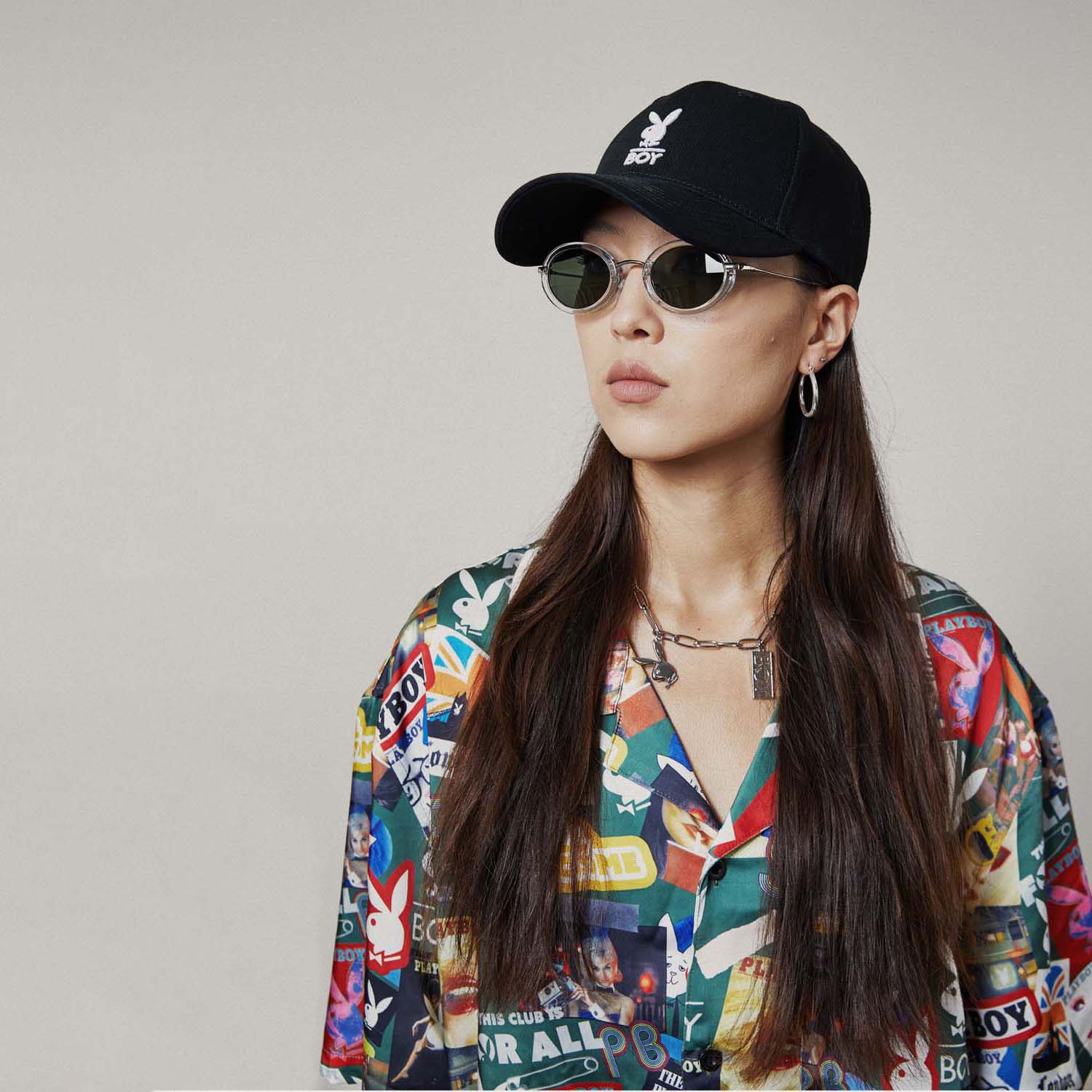 Model wearing Colourful BOY London patterned shirt with brand logos on a white background