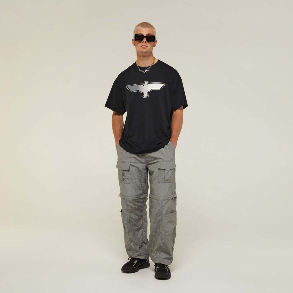 Male model wearing BOY London t-shirt on white background