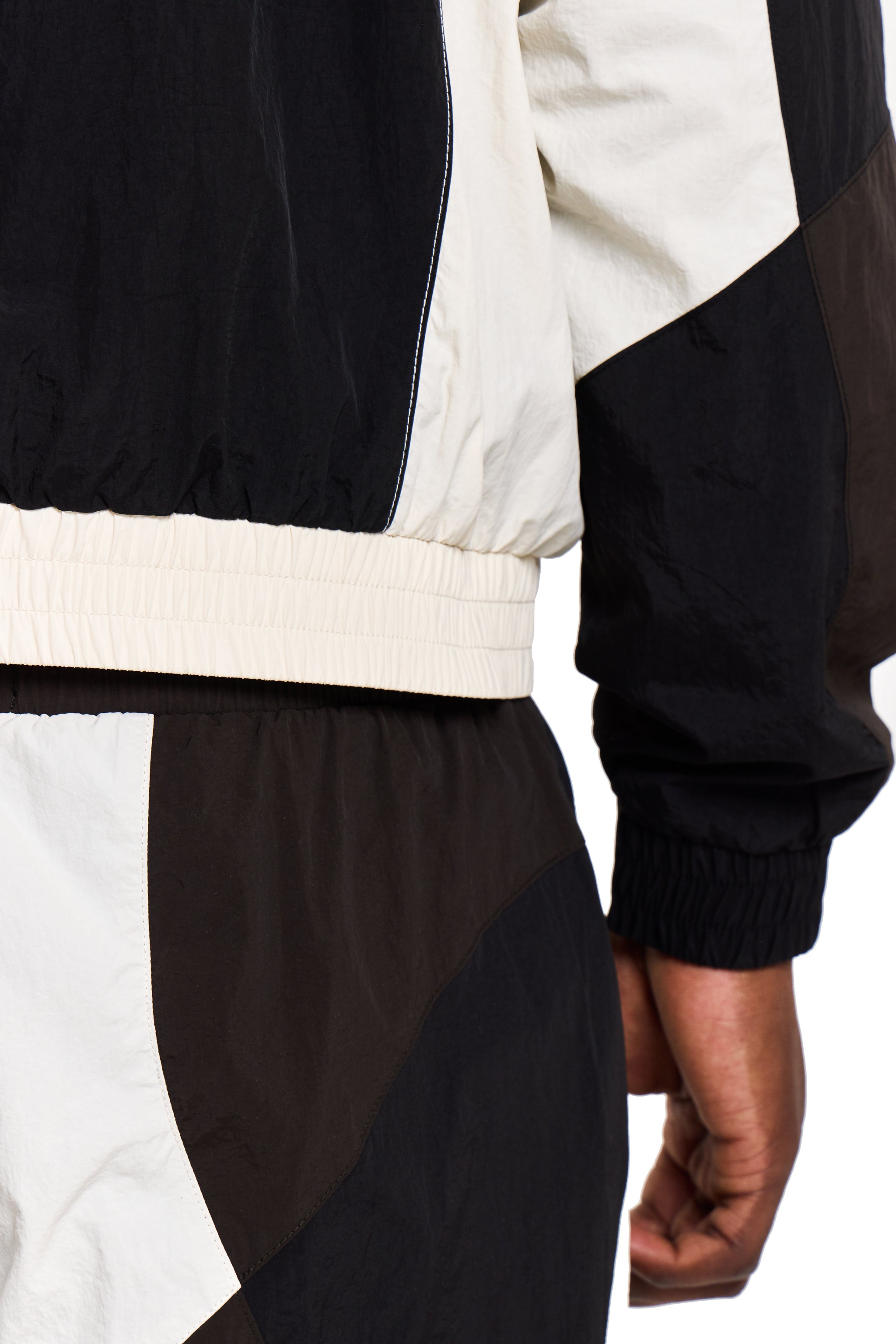 Black and white jacket with a person wearing it on a white background