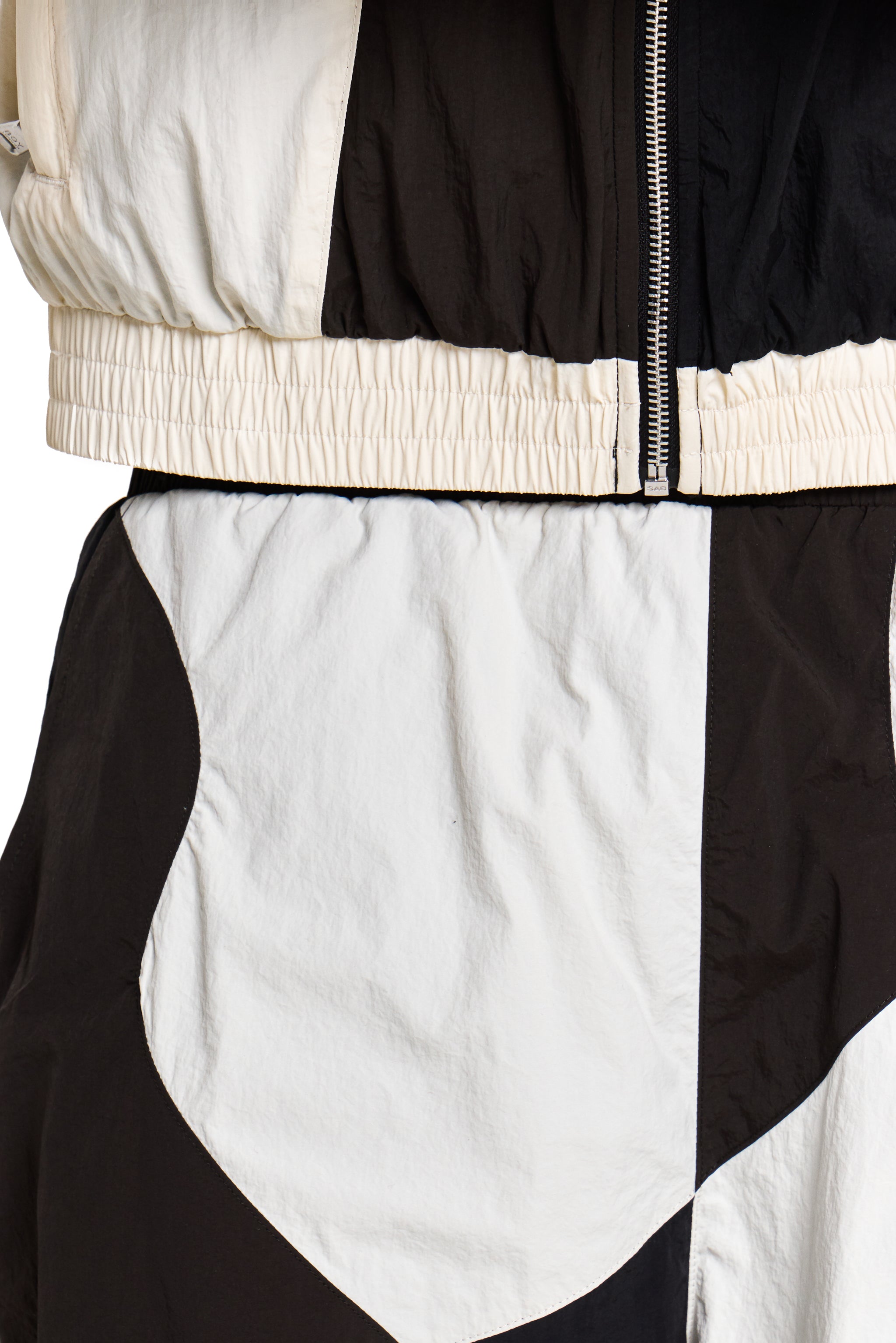 Close-up of a black and white jacket with a zipper
