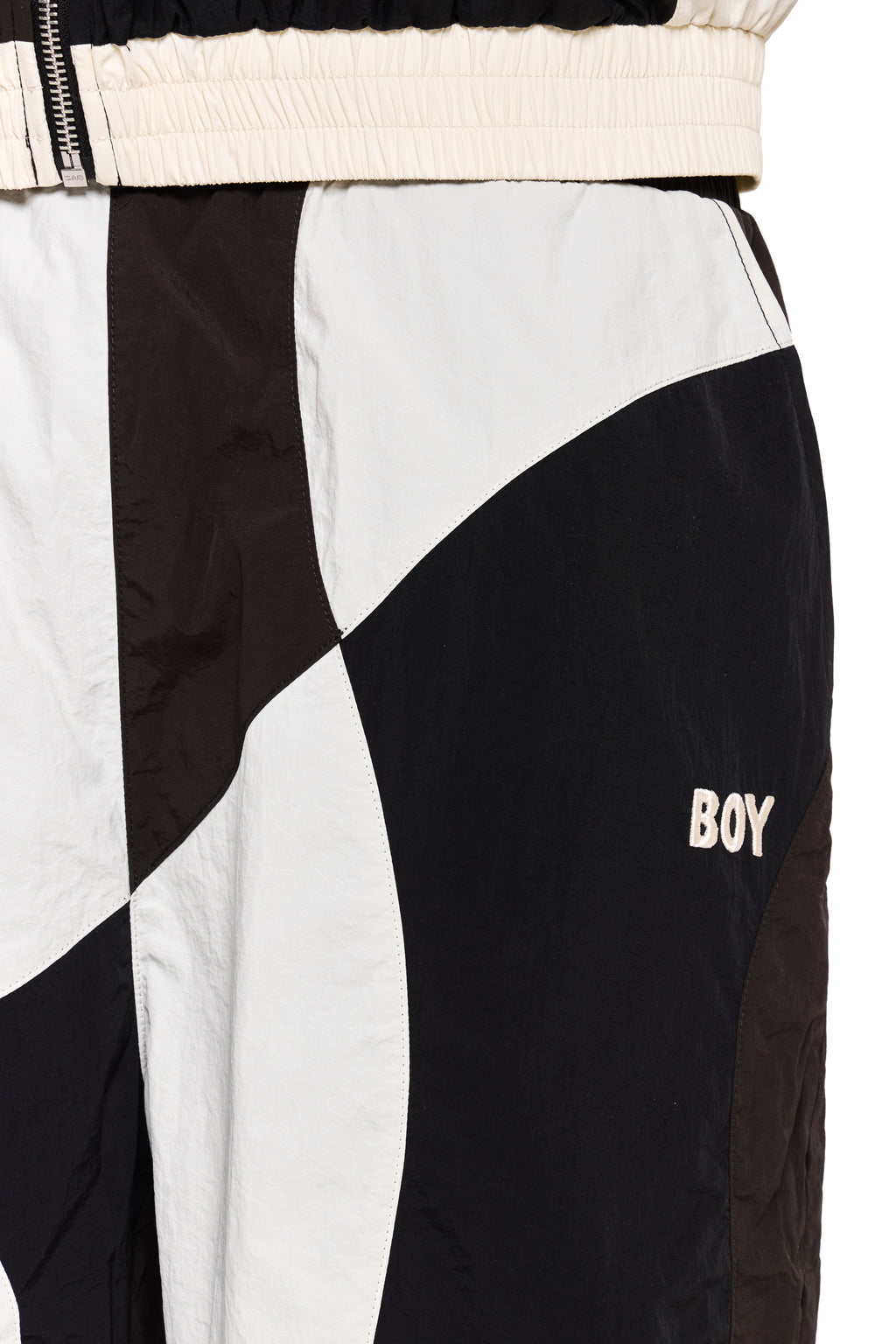 Color-blocked pants with 'BOY' branding on a white background