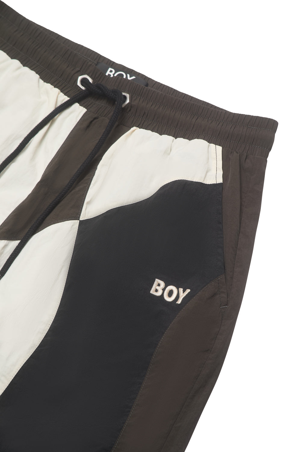 Close-up of a black and white BOY London pants on a white background