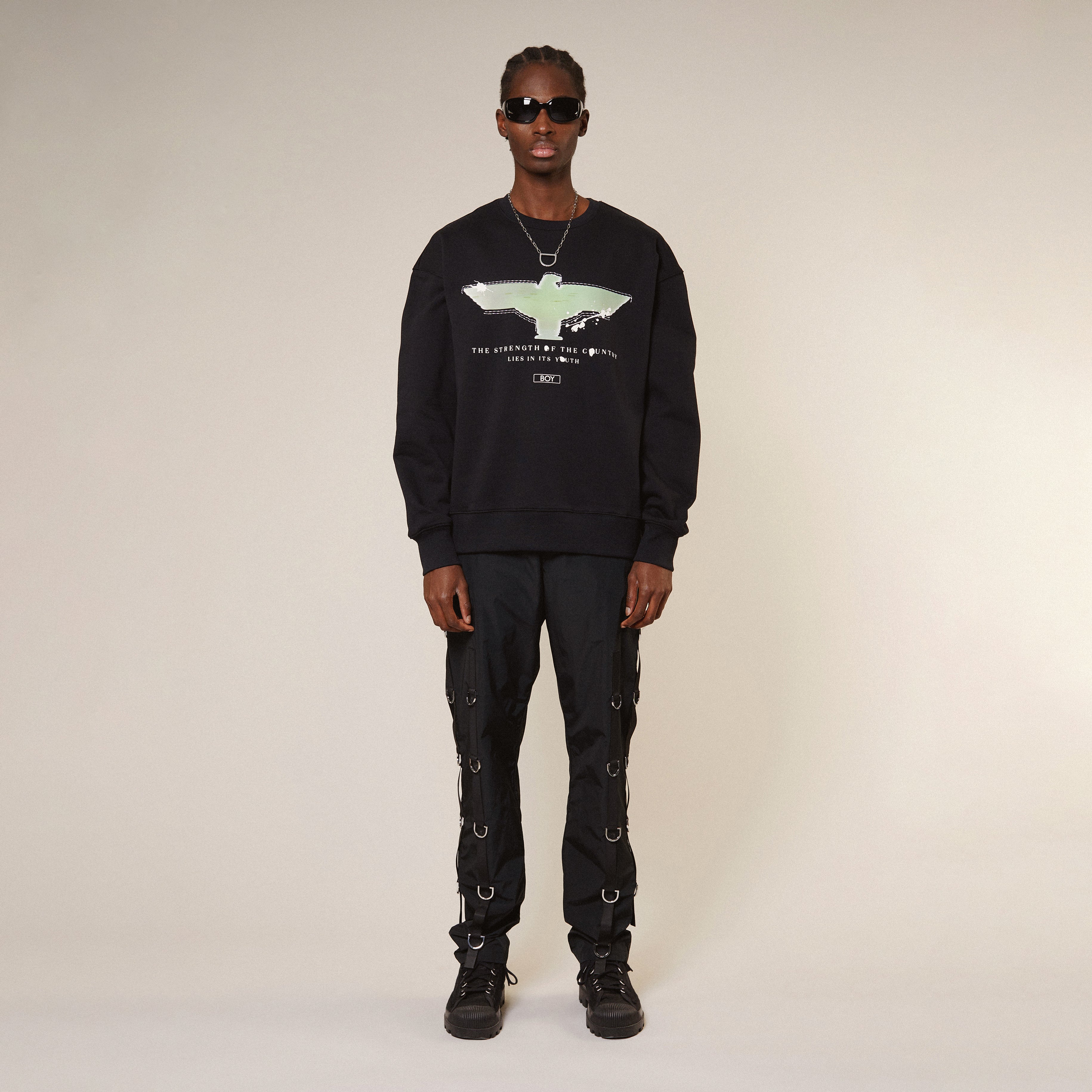 Model wearing Black Boy London sweatshirt with a graphic design on a white background
