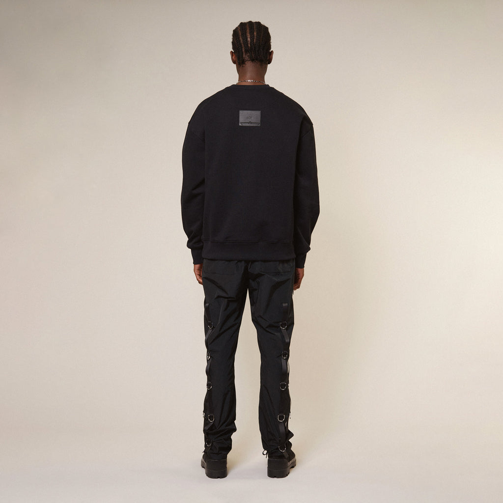 Model wearing Black Boy London sweatshirt with a graphic design on a white background